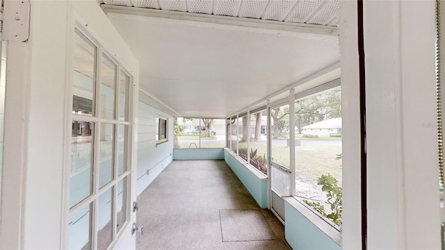 unfurnished sunroom featuring carpet flooring