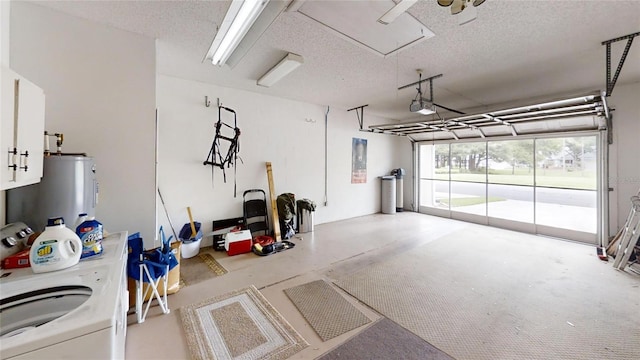 garage with washer / dryer, a garage door opener, and electric water heater