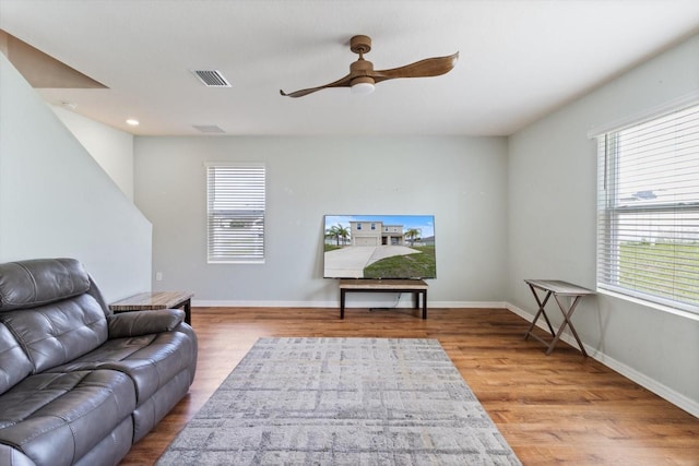 living room featuring ceiling fan and wood-type flooring