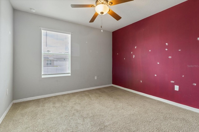 spare room with ceiling fan and carpet flooring