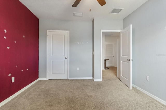 unfurnished bedroom featuring light carpet and ceiling fan