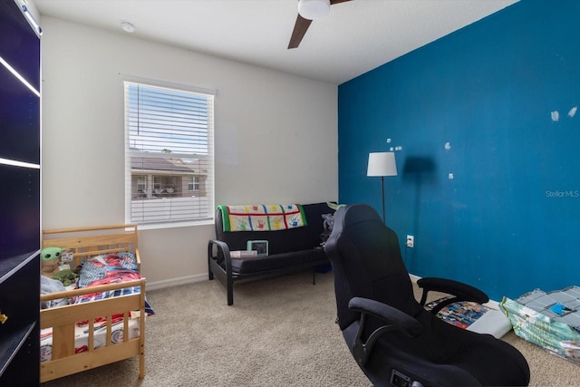 carpeted office space featuring ceiling fan