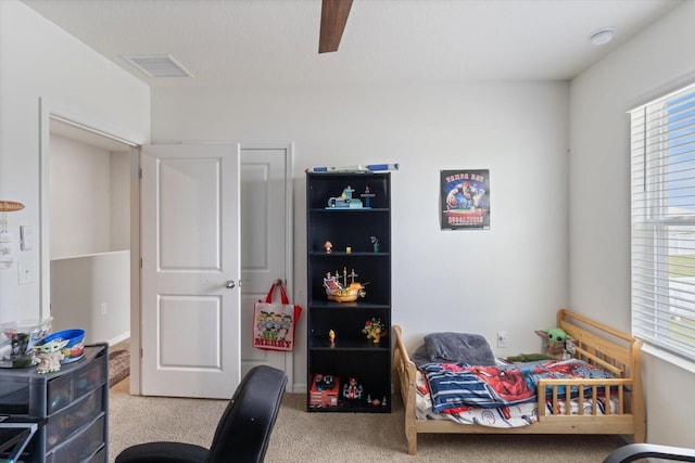 bedroom with ceiling fan and light colored carpet