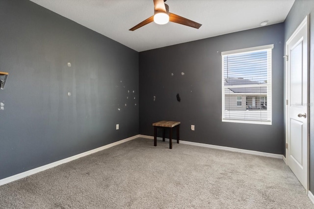 spare room with carpet floors and ceiling fan