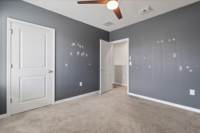 unfurnished bedroom with ceiling fan and light carpet