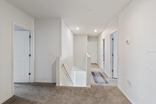 hallway featuring light colored carpet