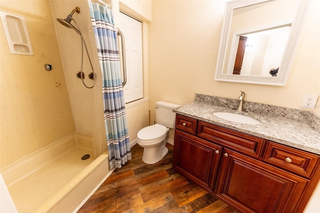 bathroom with toilet, hardwood / wood-style floors, vanity, and a shower with curtain