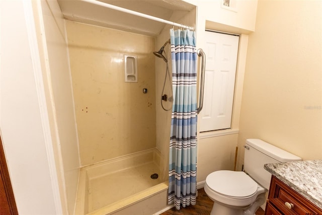 bathroom with curtained shower, hardwood / wood-style floors, vanity, and toilet