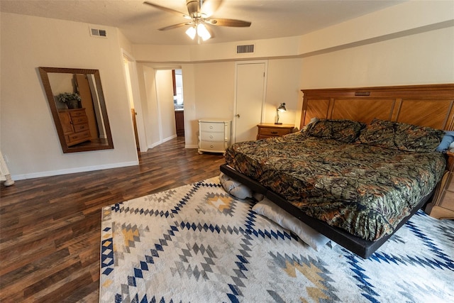 bedroom with ceiling fan and dark wood-type flooring