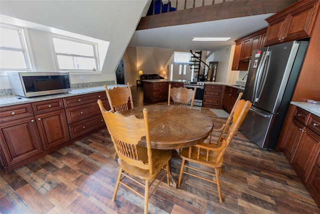 dining space featuring plenty of natural light, dark wood-type flooring, and sink