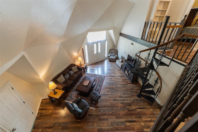 living room featuring dark hardwood / wood-style flooring and vaulted ceiling