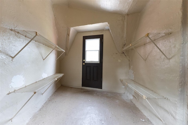 walk in closet with lofted ceiling