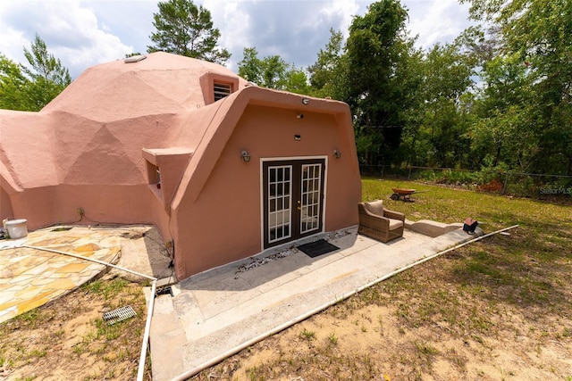 back of house featuring a patio area and french doors