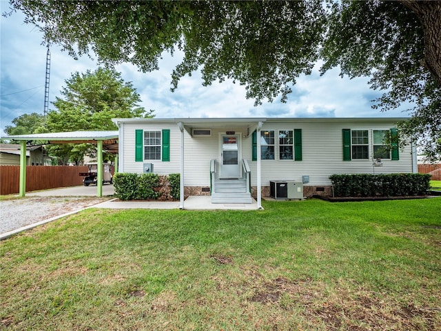 view of front of property with central AC, a front lawn, and a carport