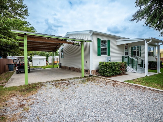 view of front of home featuring a carport and an outdoor structure