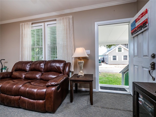 living room featuring plenty of natural light, ornamental molding, and carpet floors