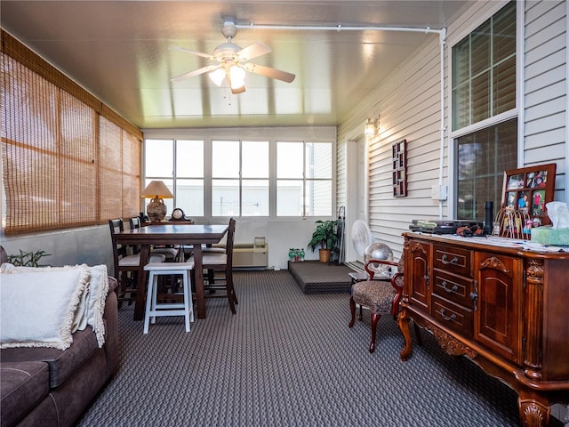 sunroom featuring ceiling fan