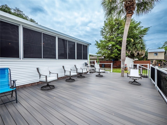 wooden deck featuring a storage shed