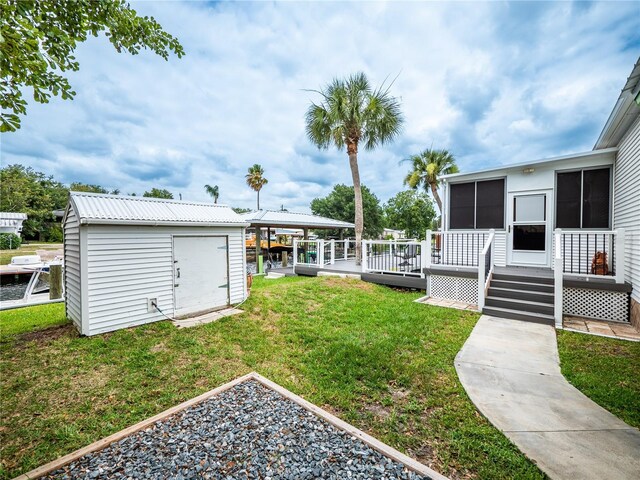 view of yard with a shed and a deck