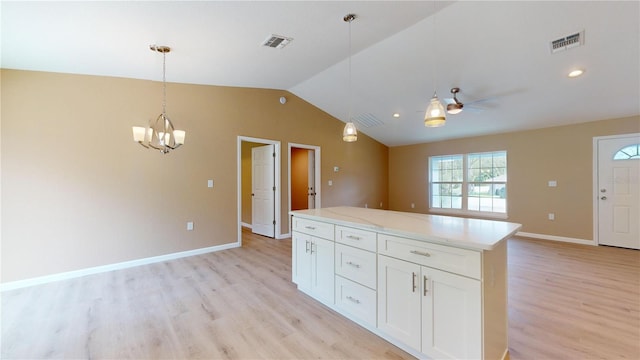 kitchen with white cabinetry, lofted ceiling, light hardwood / wood-style flooring, ceiling fan with notable chandelier, and pendant lighting