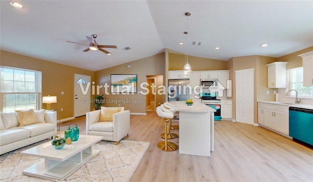 living room with lofted ceiling, sink, ceiling fan, and light wood-type flooring