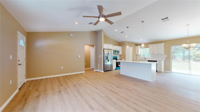 kitchen featuring sink, appliances with stainless steel finishes, a kitchen island, pendant lighting, and white cabinets