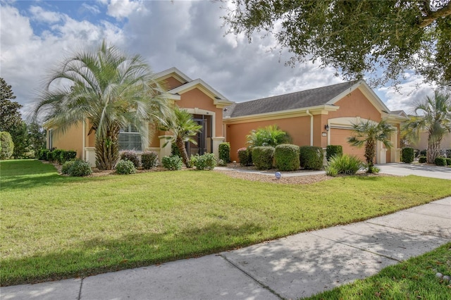 view of front of property with a garage and a front lawn