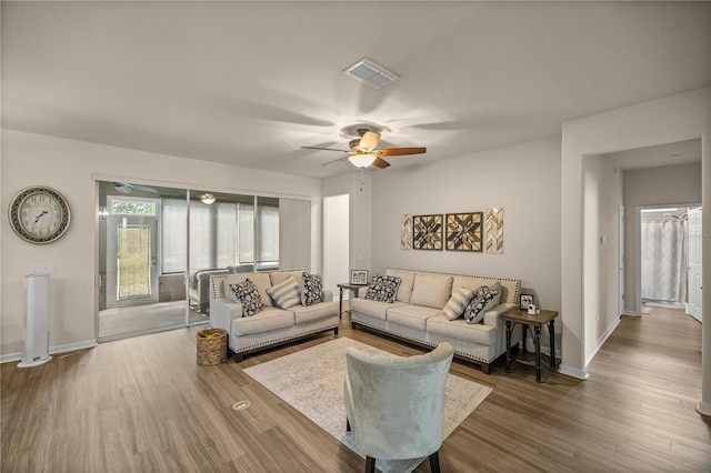 living room featuring ceiling fan and wood-type flooring