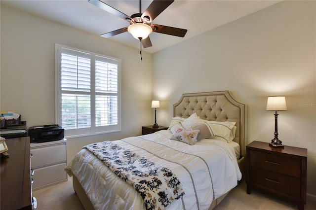 bedroom with ceiling fan, multiple windows, and light carpet