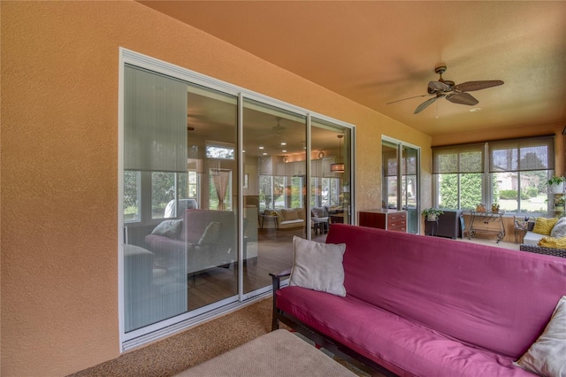 sunroom / solarium featuring ceiling fan and a healthy amount of sunlight