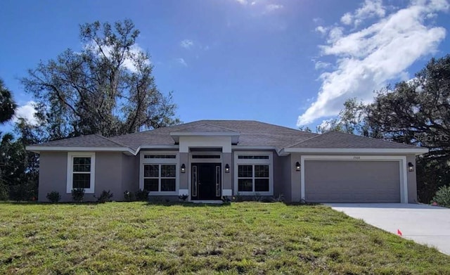 view of front of home with a front yard and a garage