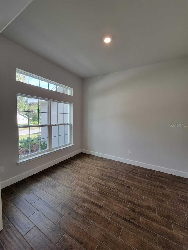 unfurnished room with dark hardwood / wood-style floors