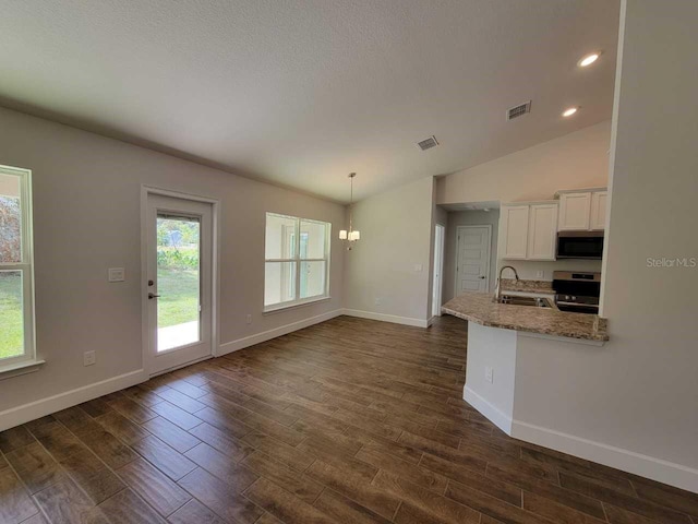 kitchen featuring white cabinets, appliances with stainless steel finishes, dark hardwood / wood-style flooring, and light stone counters