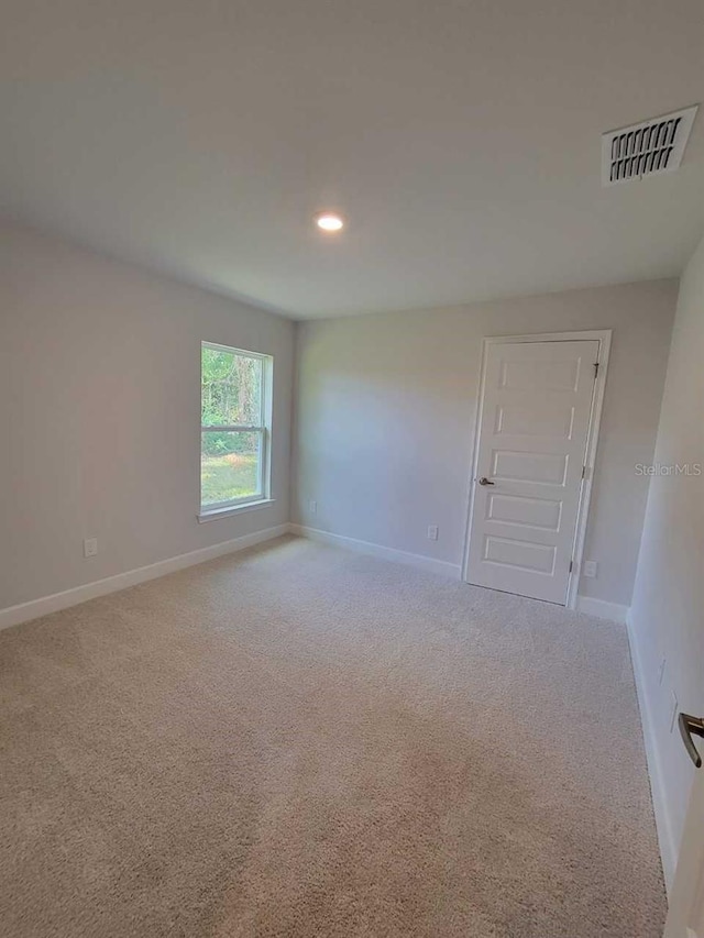 unfurnished room with light carpet