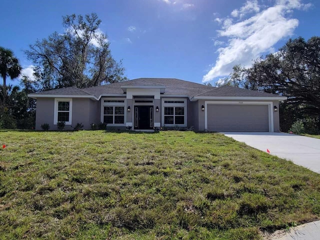 view of front of home with a garage and a front lawn