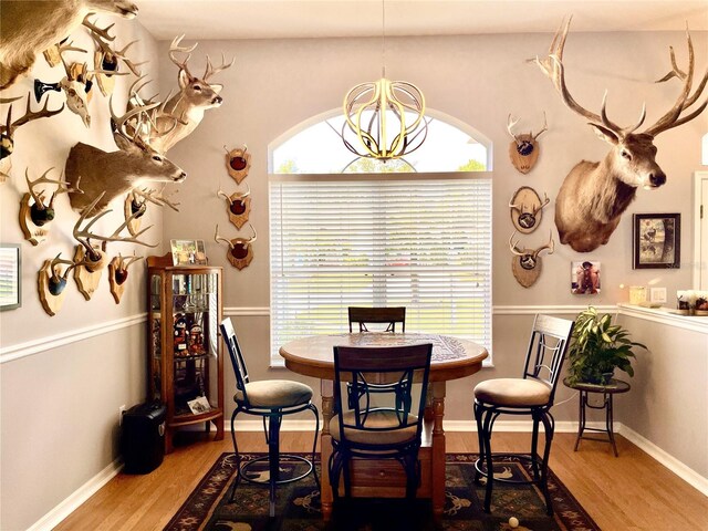 dining room with light hardwood / wood-style floors and an inviting chandelier