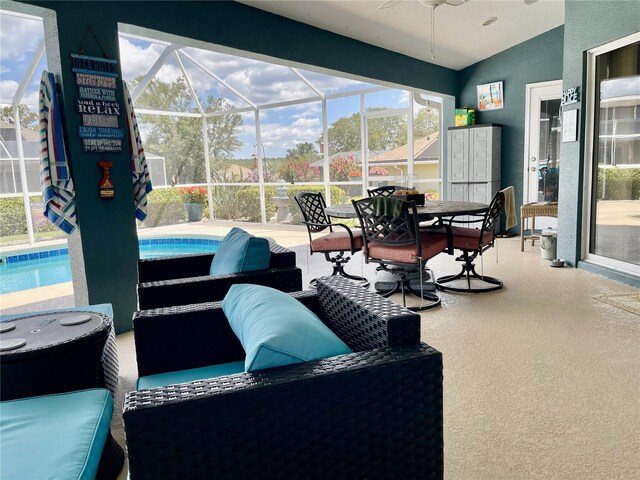 sunroom / solarium featuring lofted ceiling and a pool