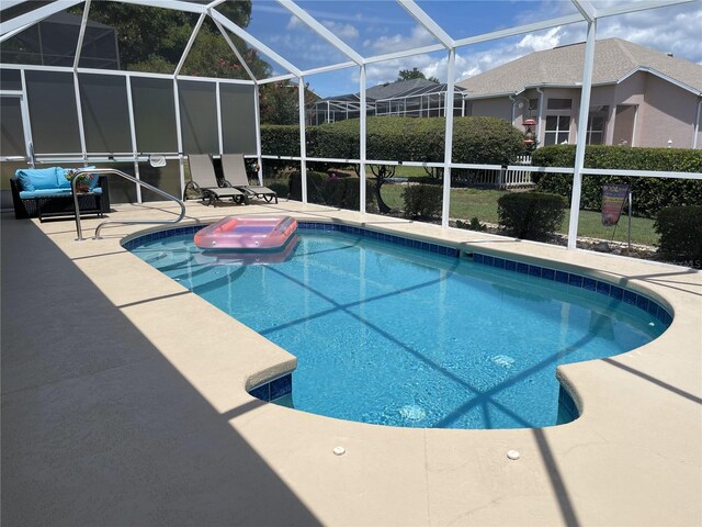 view of swimming pool with a patio and glass enclosure