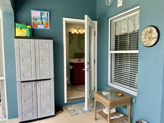 interior space with connected bathroom and sink