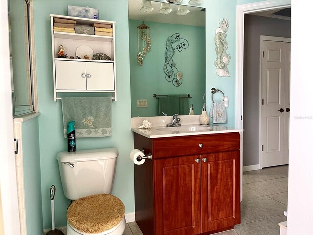 bathroom with tile patterned flooring, vanity, and toilet