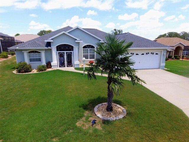 ranch-style house featuring a front yard and a garage