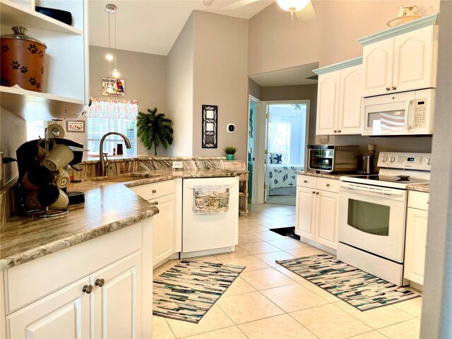 kitchen with white cabinetry, sink, hanging light fixtures, white appliances, and light tile patterned floors