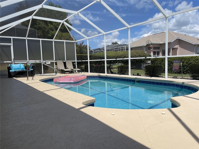 view of pool with a lanai and a patio area