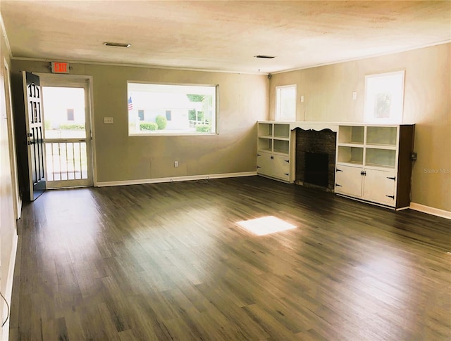 unfurnished living room with dark hardwood / wood-style flooring and ornamental molding