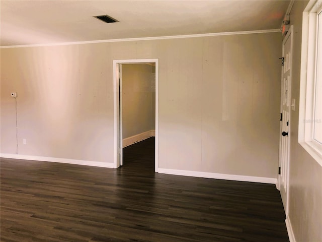 unfurnished room with crown molding and dark hardwood / wood-style flooring