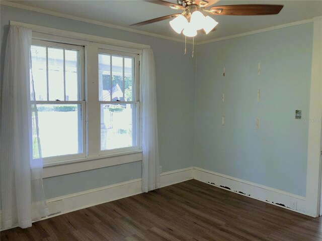 unfurnished room with ceiling fan, crown molding, and dark wood-type flooring