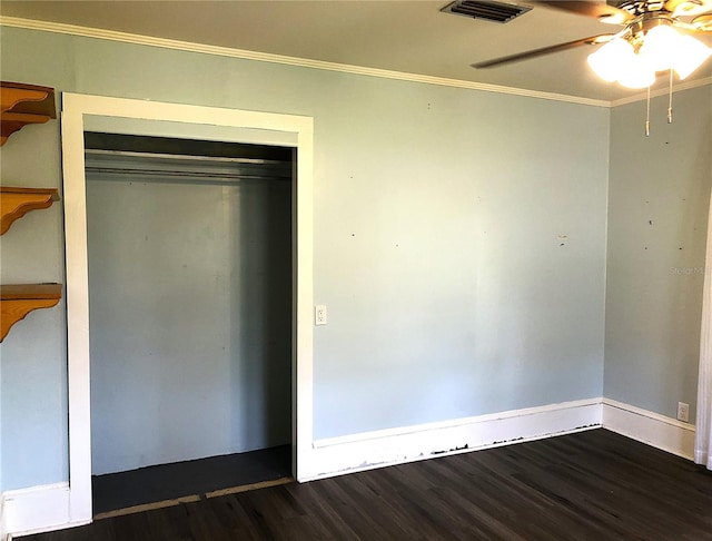 unfurnished bedroom featuring crown molding, ceiling fan, wood-type flooring, and a closet