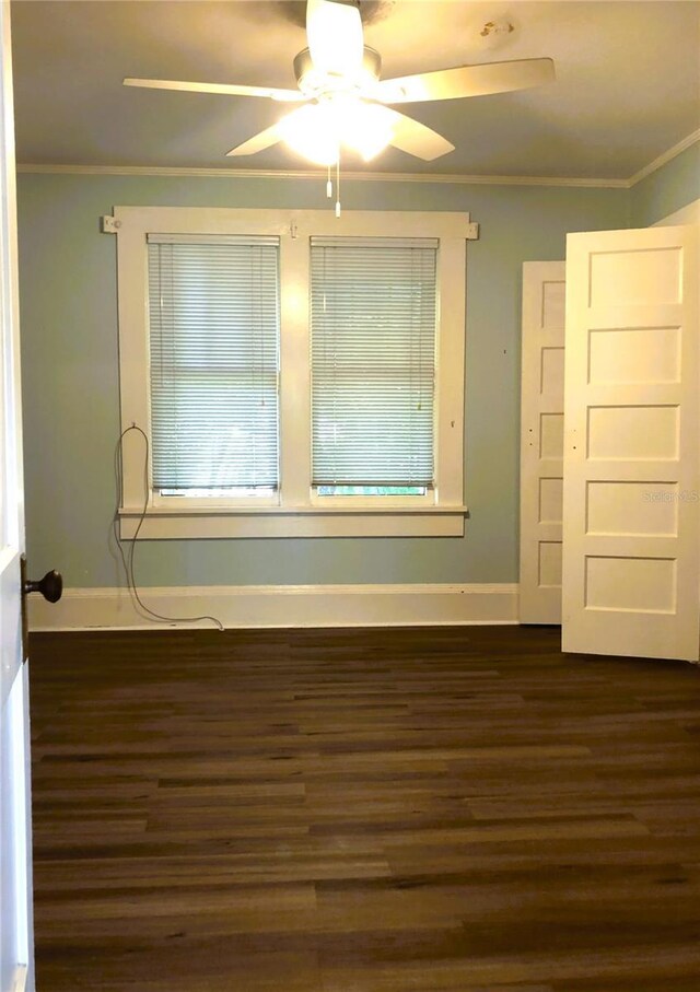 spare room featuring ceiling fan, hardwood / wood-style floors, and crown molding