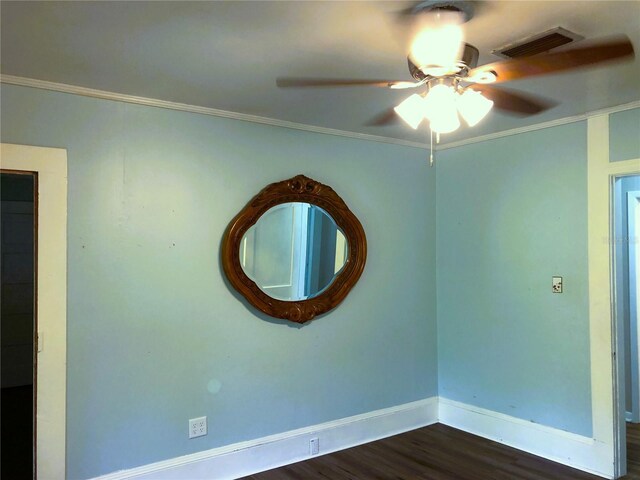 empty room with ornamental molding, ceiling fan, and dark hardwood / wood-style floors