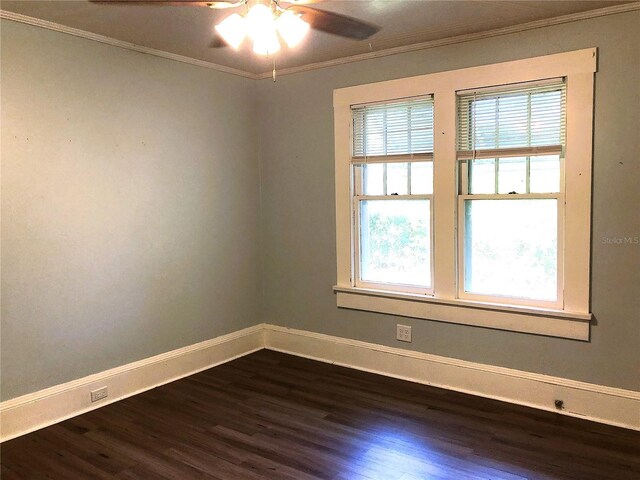 unfurnished room featuring dark hardwood / wood-style floors, ornamental molding, a wealth of natural light, and ceiling fan